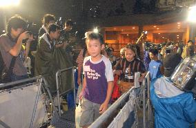 Children visit homes on evacuated Miyakejima Island+